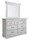Kanwyn King Panel Bed with Mirrored Dresser, Chest and 2 Nightstands